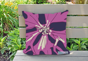Ragged Robin cushion/throw pillow cover, designed by Anne Harrington Rees, on a garden bench.