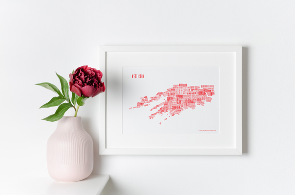 West Cork placename map in red ink, designed by Anne Harrington Rees, framed, hanging on a wall