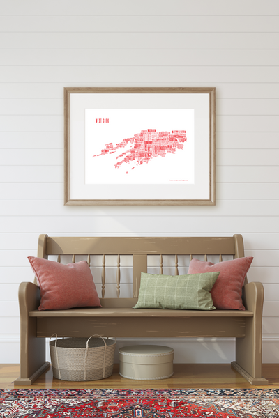 West Cork placename map in red, designed by Anne Harrington Rees, framed, hanging on a wall over a bench
