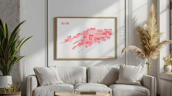 West Cork placename map in red ink, designed by Anne Harrington Rees, framed, hanging on a wall with shadows