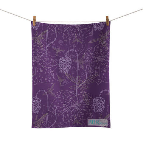 Colourful gift – Purple, White and Yellow Fritillaria flower design tea towel hanging from clothesline, white background. Designed by Anne Harrington Rees. Designed, printed and made in Ireland.